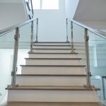 minimalistic glass system with surface mount posts in brushed stainless steel
