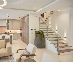 glass railing system with brushed stainless steel bump out posts and handrail