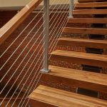 cable rail silver powder coat posts texture against brick