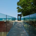 Glass Railing Along Catwalk To Balcony